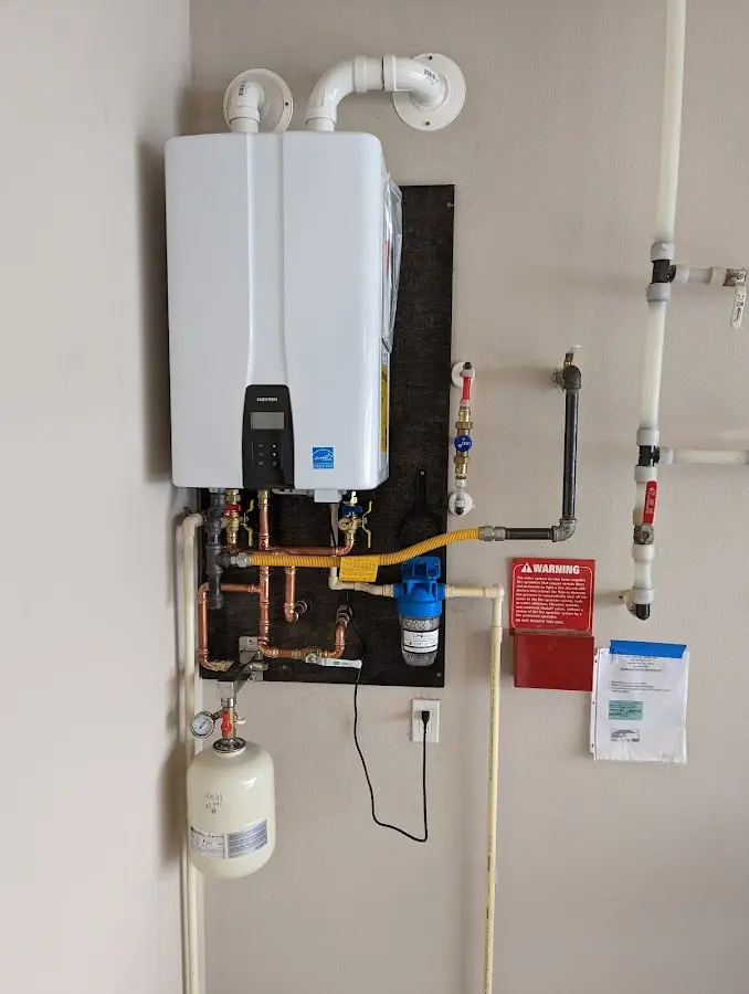 Professional plumber installing copper piping in a Hunters Creek Village home